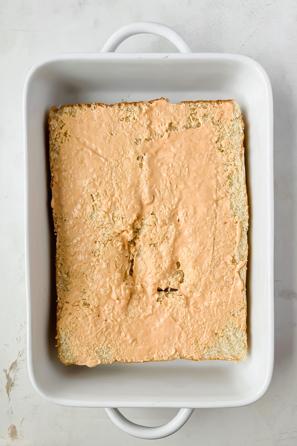 sauce spread on hawaiian slider buns.