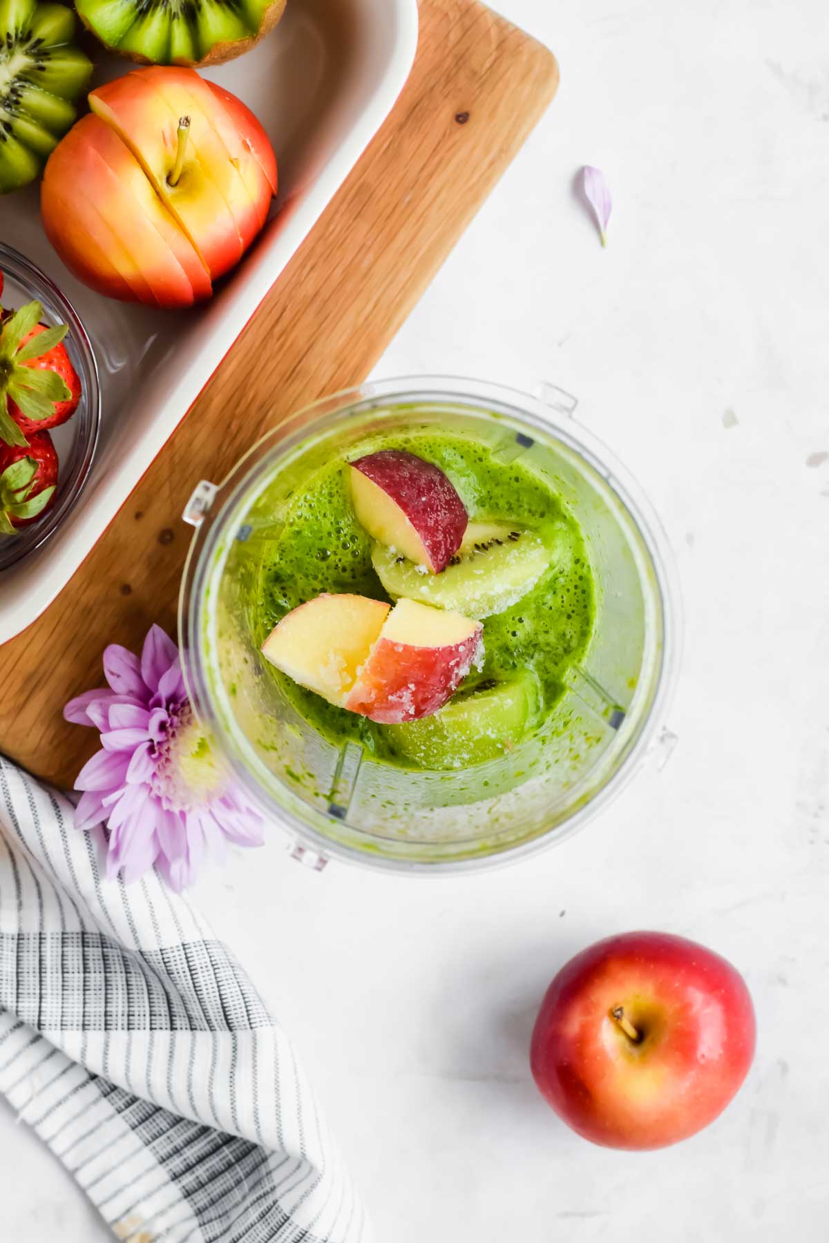 Ingredients for Apple Kiwi Green Smoothie in a blender cup.