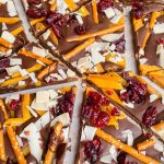 Cracked chocolate bark with pretzels, dried fruit, and coconut shavings.
