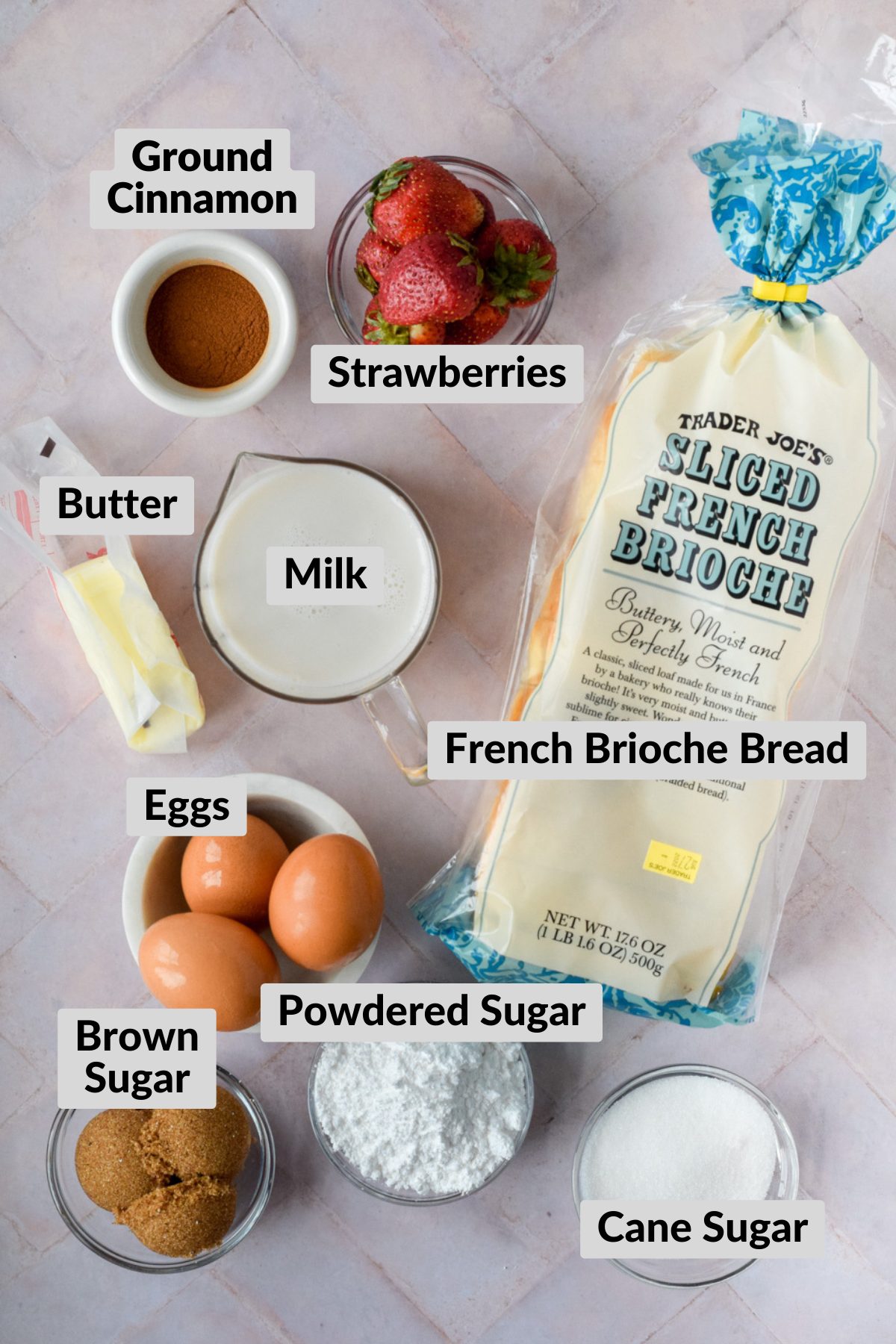 ingredients for churro french toast in individual bowls spread on stone background.