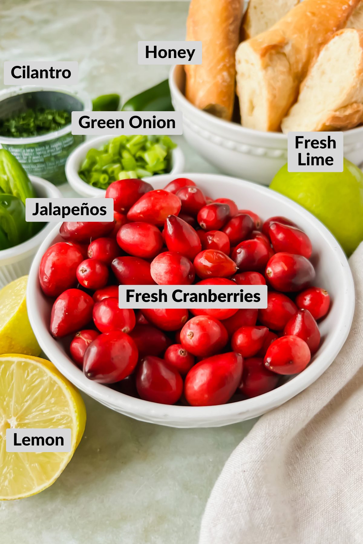 ingredients for cranberry jalapeño salsa in individual bowls.