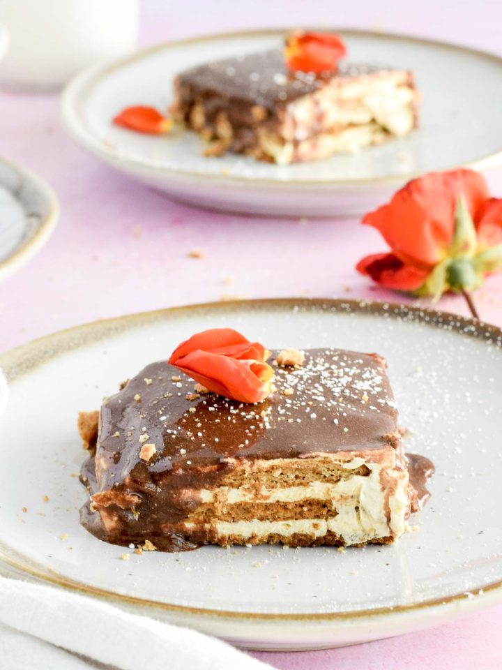 slice of no bake eclair icebox cake dusted with powdered sugar.