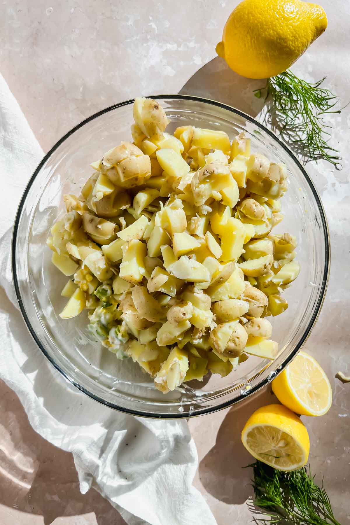 boiled and chopped potatoes in glass mixing bowl.