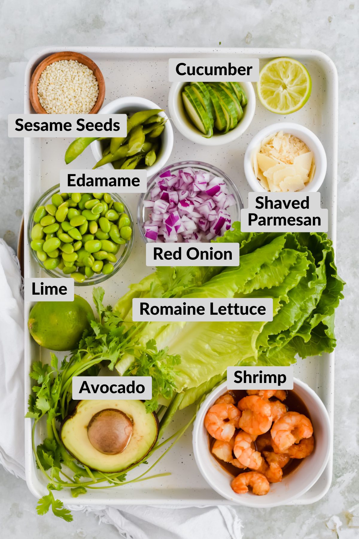 ingredients for honey teriyaki shrimp lettuce wraps in individual bowls on white baking tray.