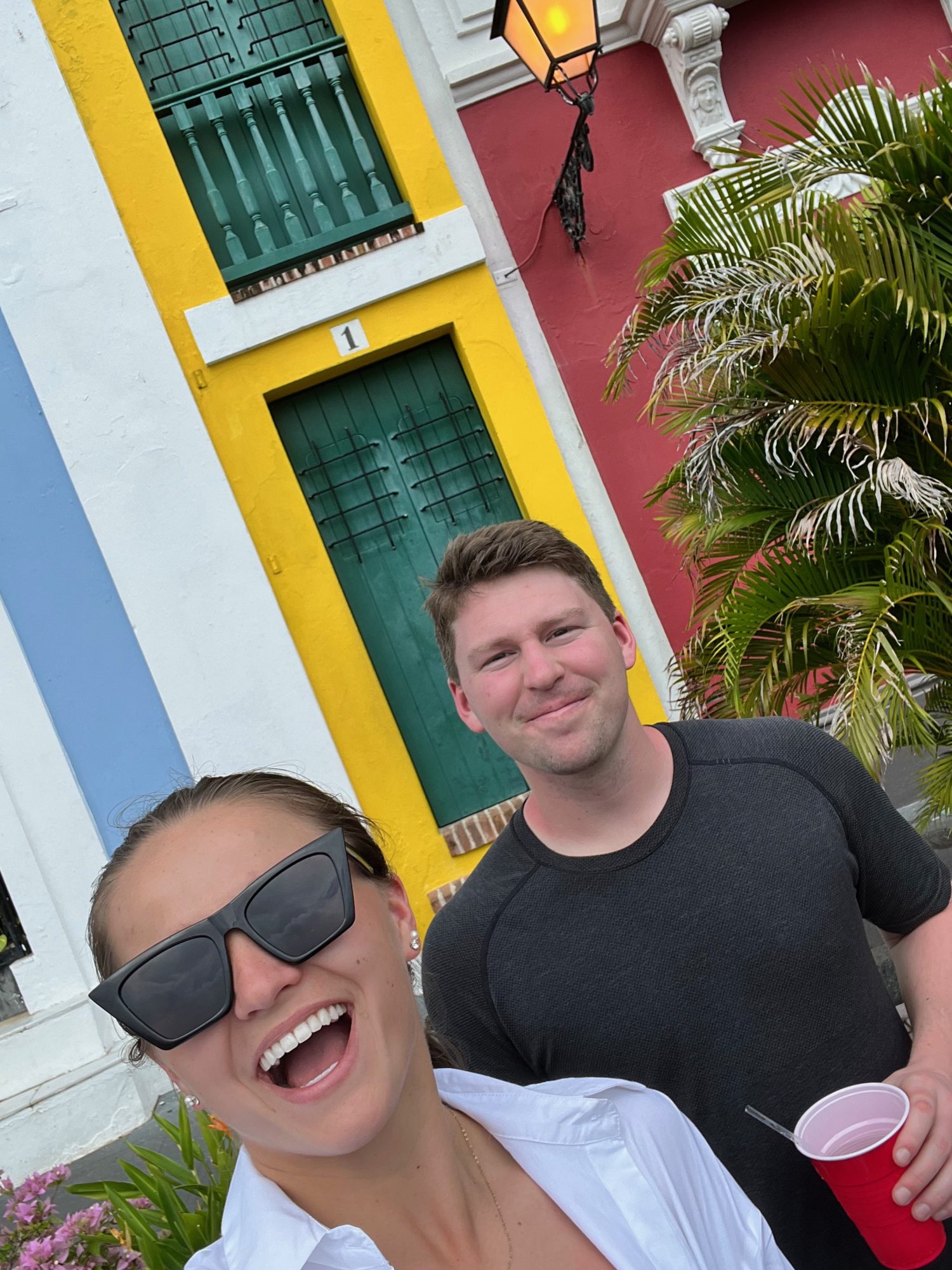 two people taking a selfie in front of the worlds smallest apartment.
