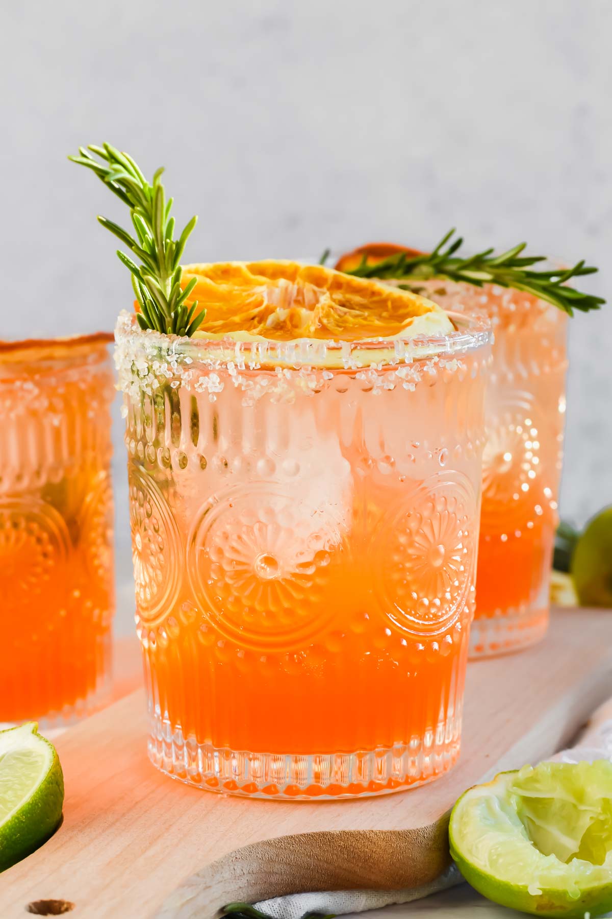 a Italian Margarita garnished with fresh rosemary and dried oranges.