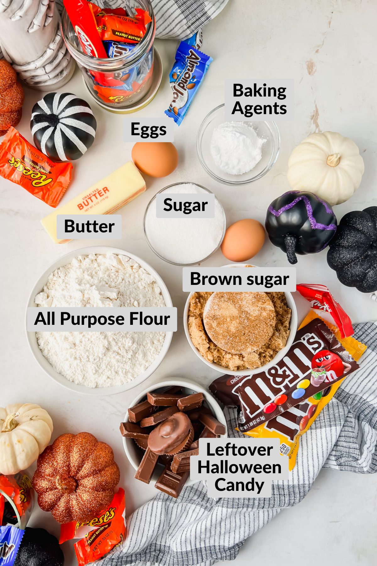 ingredients for leftover halloween candy cookies in individual white bowls.