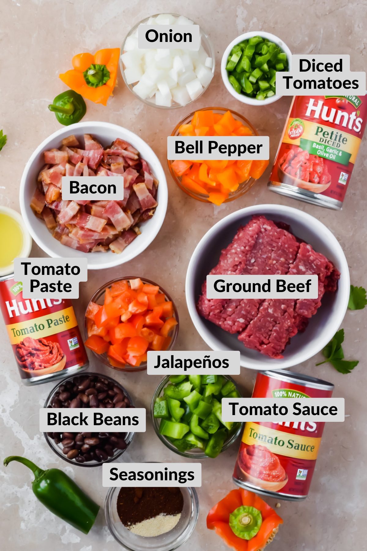 ingredients for smokey bacon chili in individual bowls.