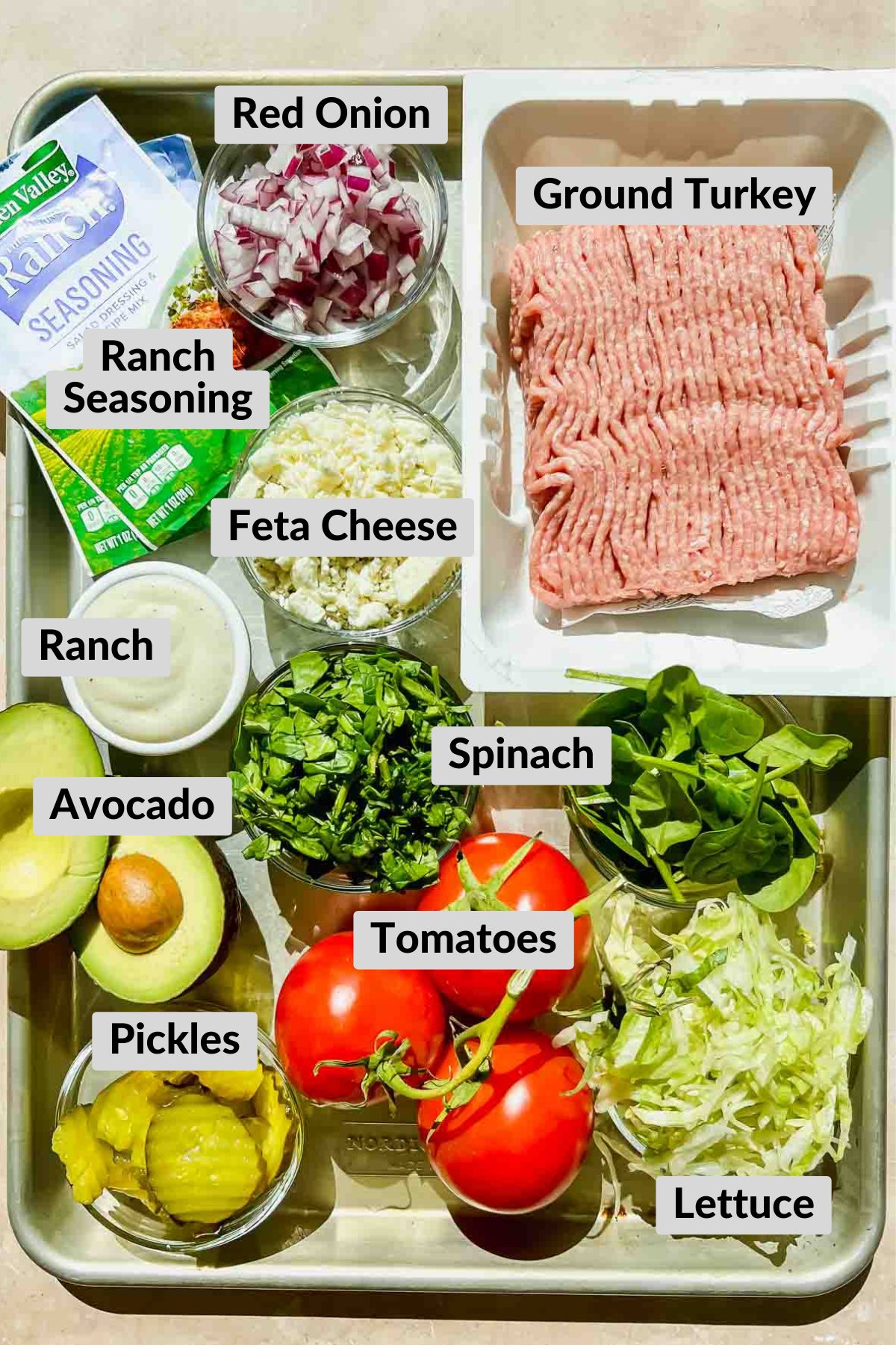 Ingredients for Turkey Burgers on a metal sheet pan. 