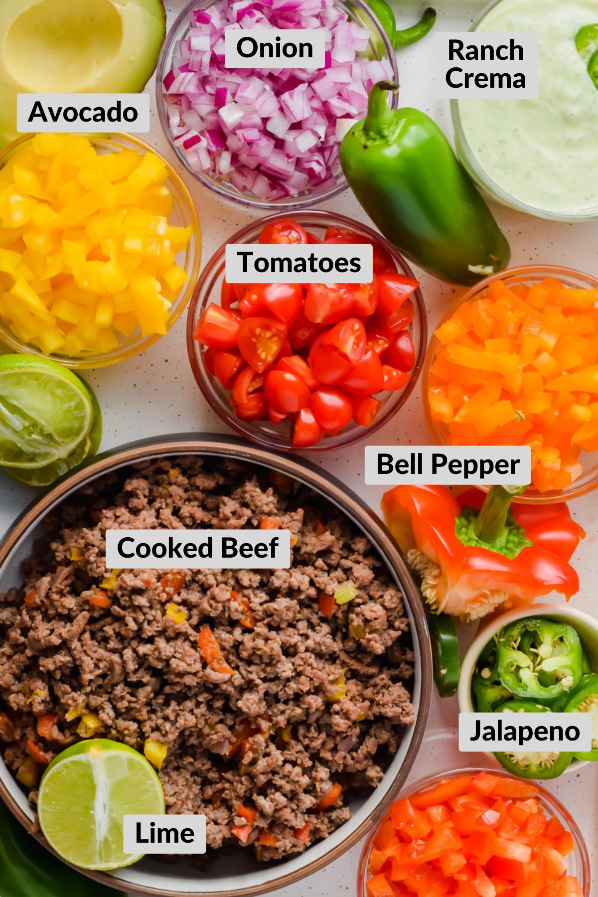 ingredients for ranch taco salad chopped up in individual bowls.
