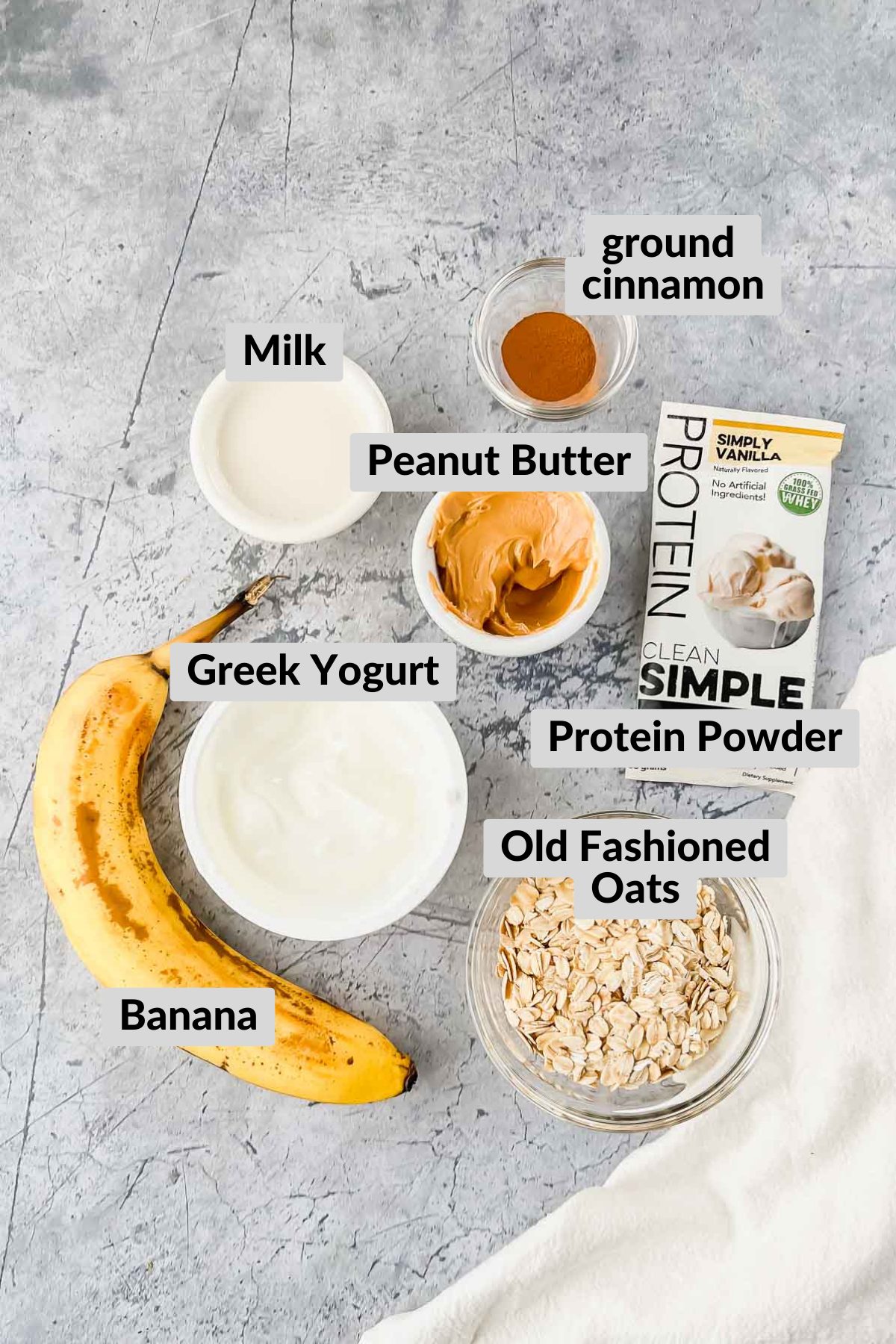 ingredients for banana peanut butter overnight oats  on grey background.