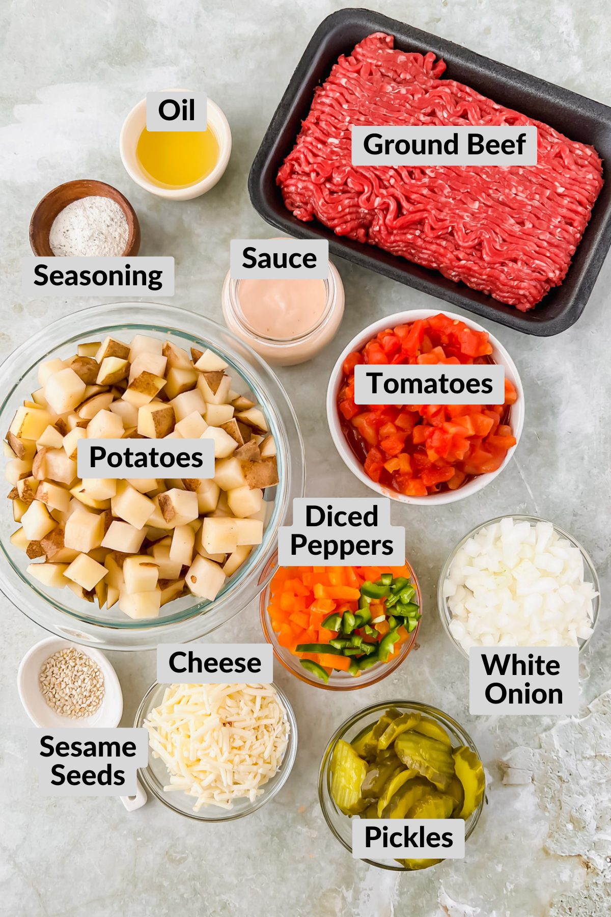ingredients for big mac casserole in individual bowls on green background. 