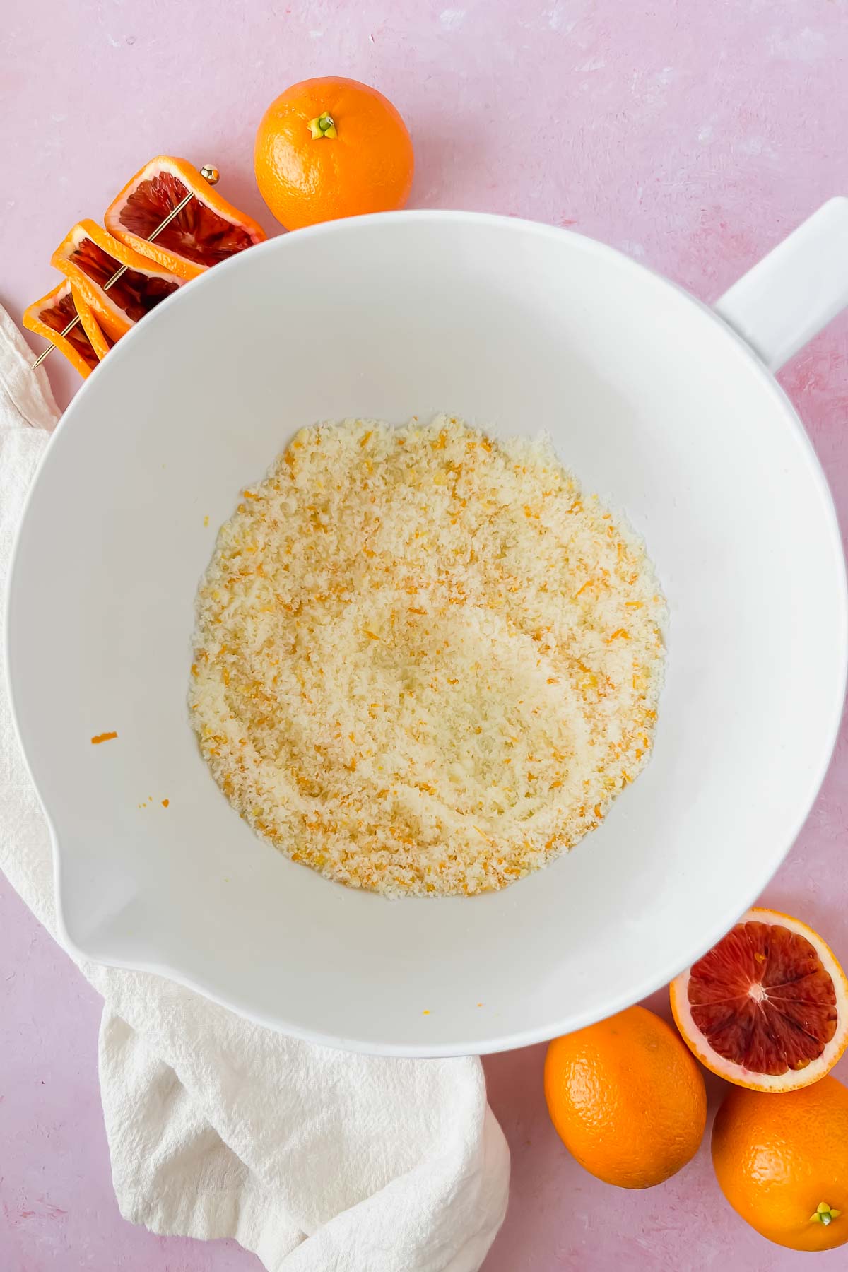 butter and blood orange zest mixed in white mixing bowl.