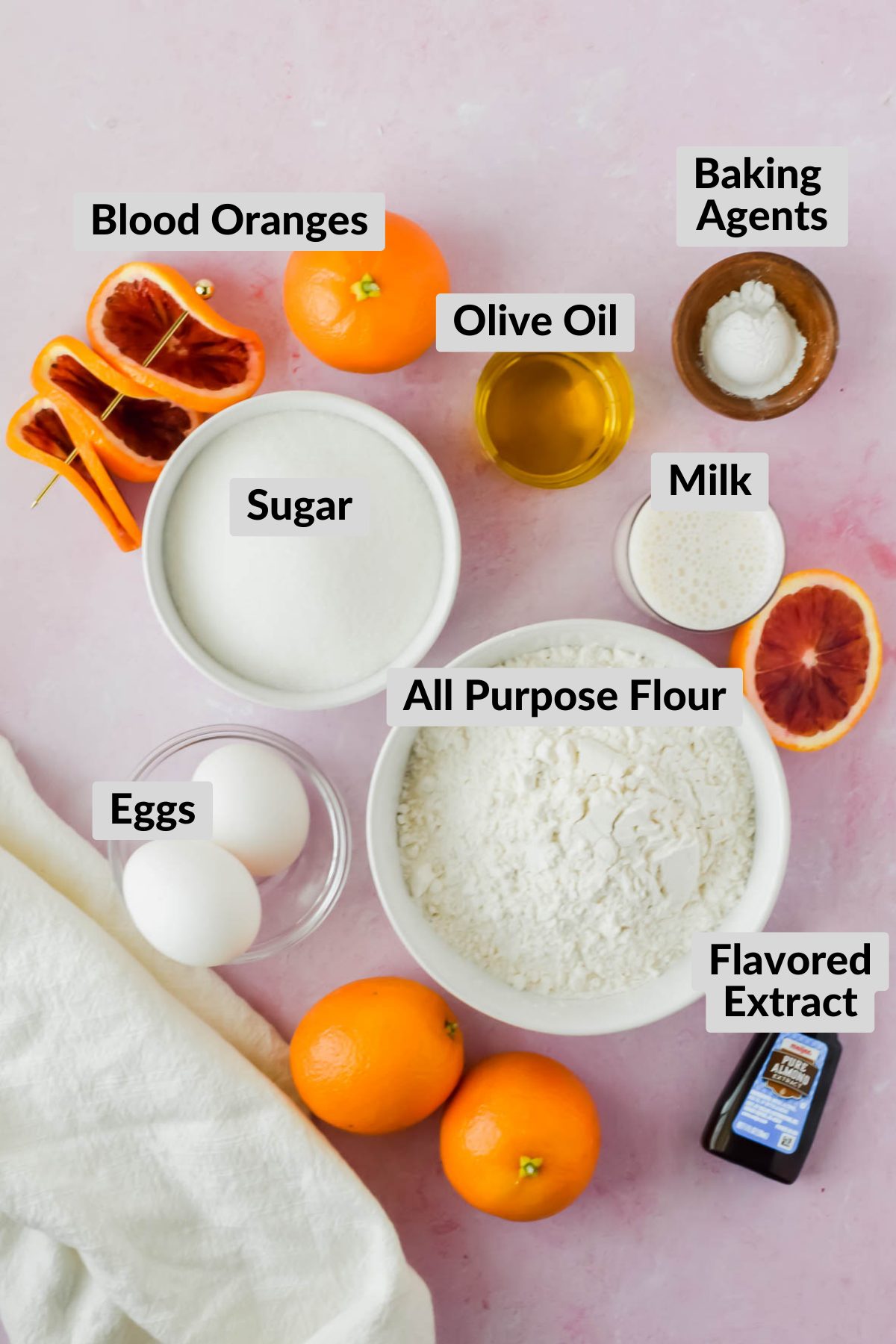 ingredients for Blood Orange Olive Oil Cake in individual bowls on pink background.