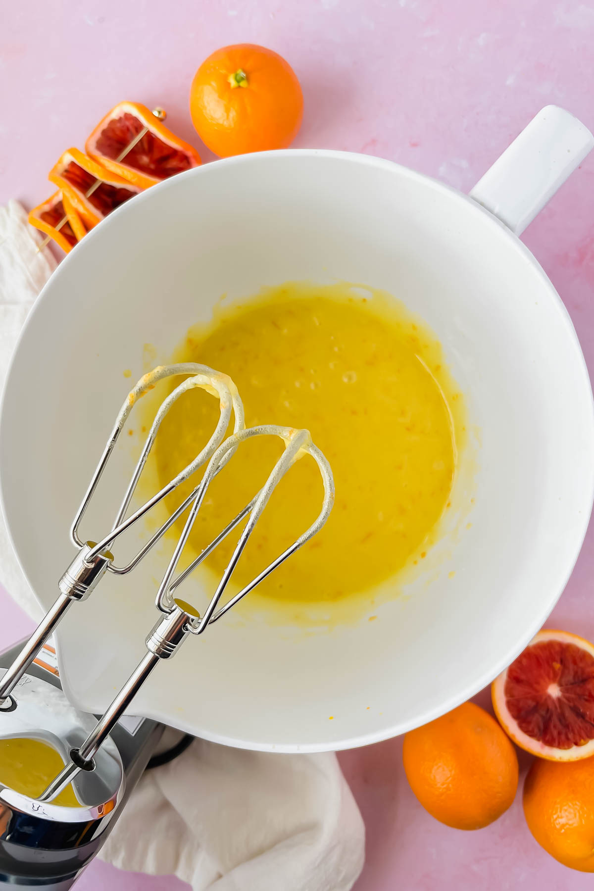 blood orange olive oil cake wet ingredients mixed in white mixing bowl.