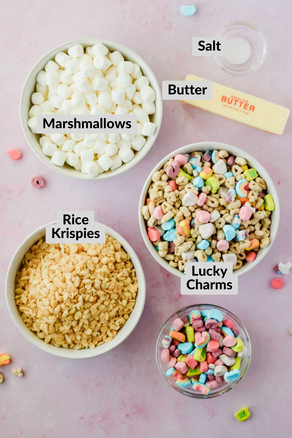 ingredients for lucky charm rice krispie treats in individual bowls with labels.