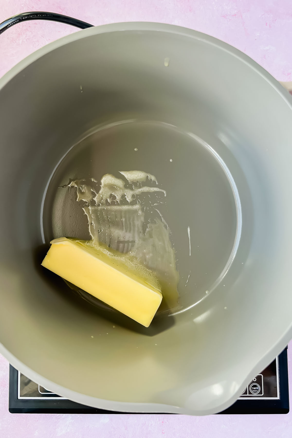 butter melting in gray sauce pot.