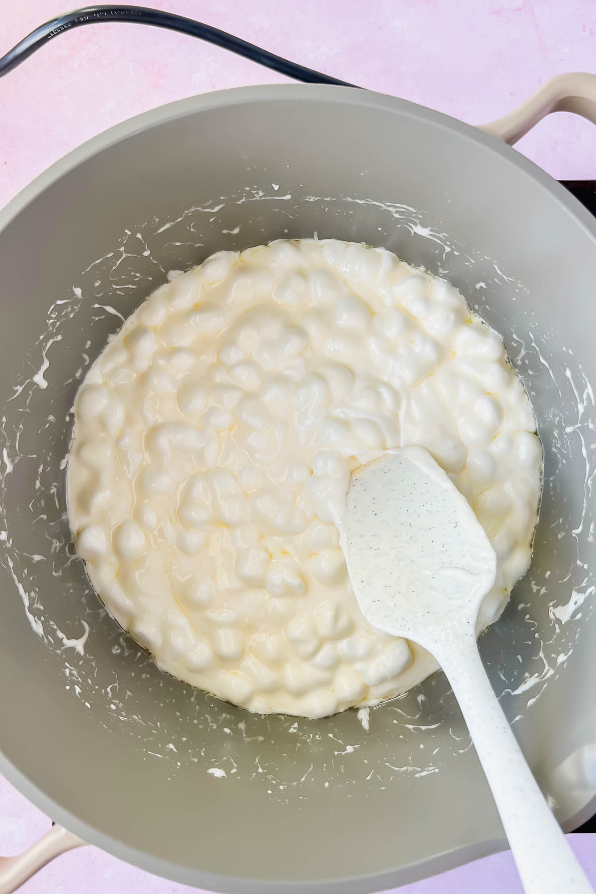 marshmallows melting in gray sauce pot.