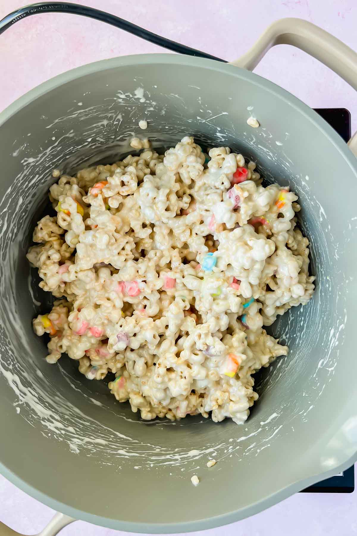 marshmallow covered cereal mixture in gray sauce pot.