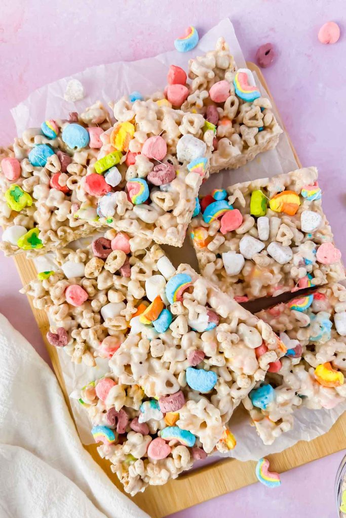lucky charm rice krispie treats cut into squares on white parchment.