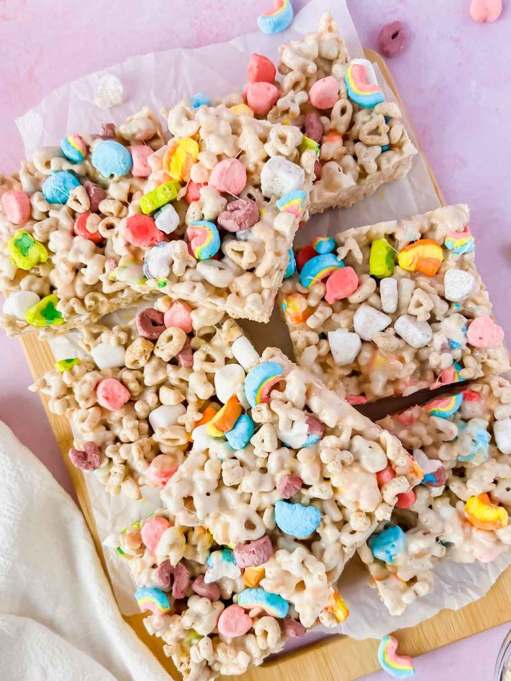 lucky charm rice krispie treats cut into squares on white parchment.