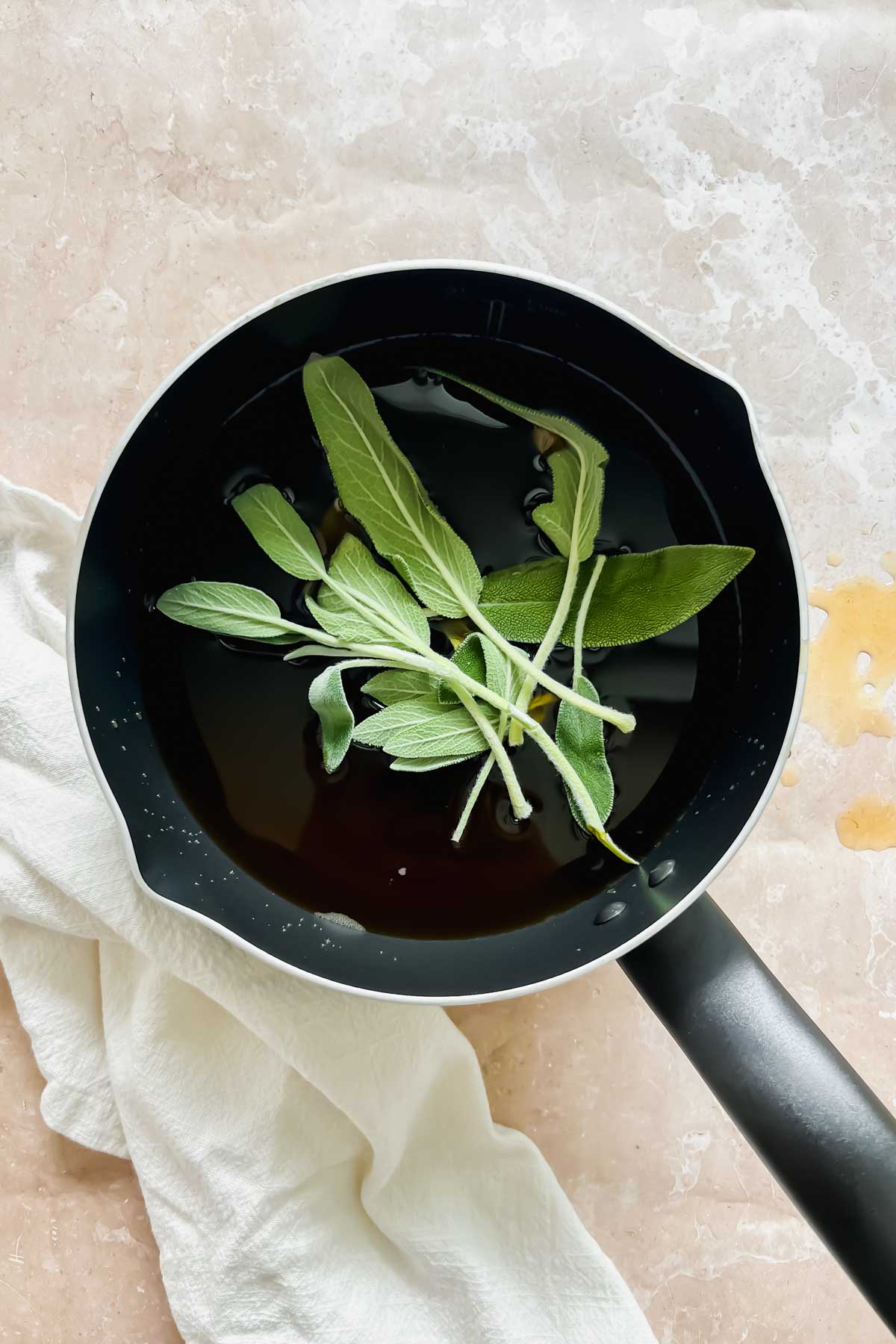 sauce pot heated with vegetable broth, water, and fresh sage. 