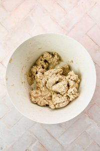 oat flour biscuit dough in white mixing bowl.