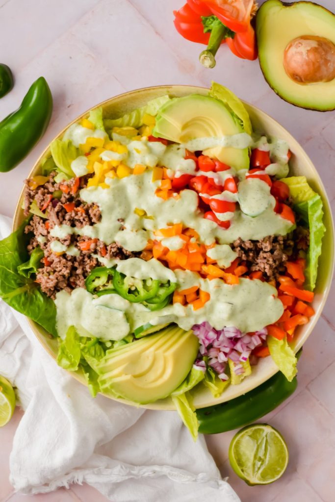 big bowl of ranch taco salad dressed with creamy jalape&ntilde;o sauce before tossing.