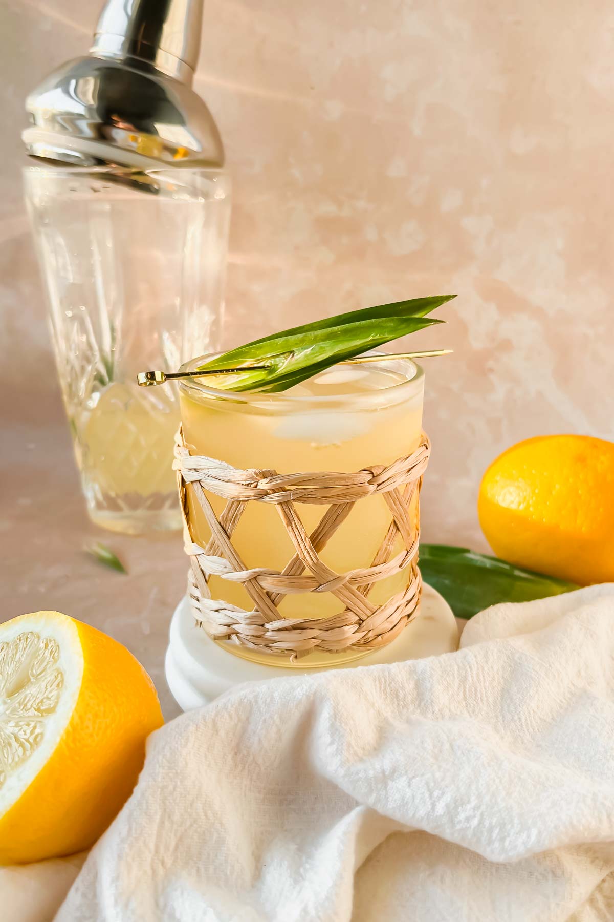 irish lemonade garnished with pineapple leaves on gold skewer.