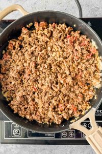 cooked and seasoned ground beef in skillet.