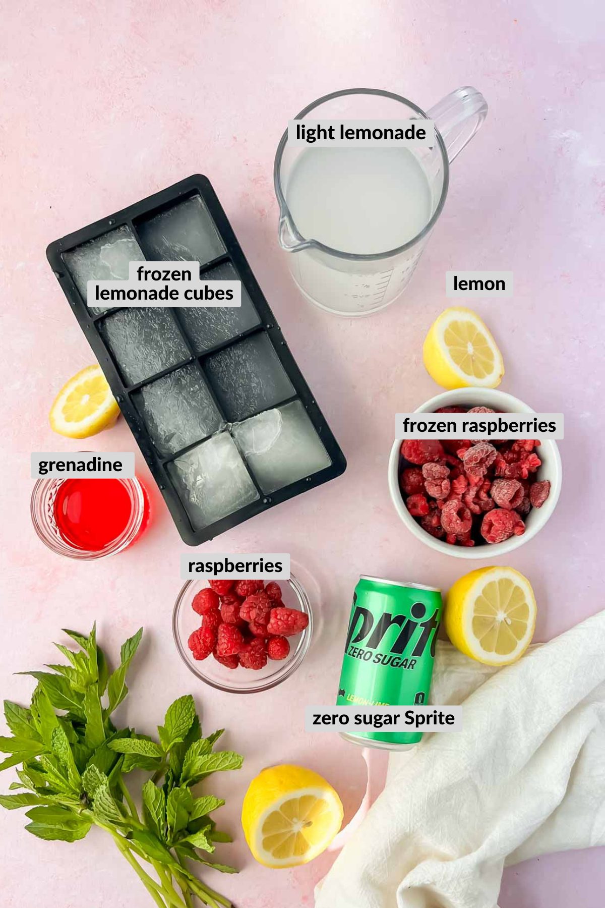labeled frozen raspberry lemonade refresher ingredients spread on light pink background.