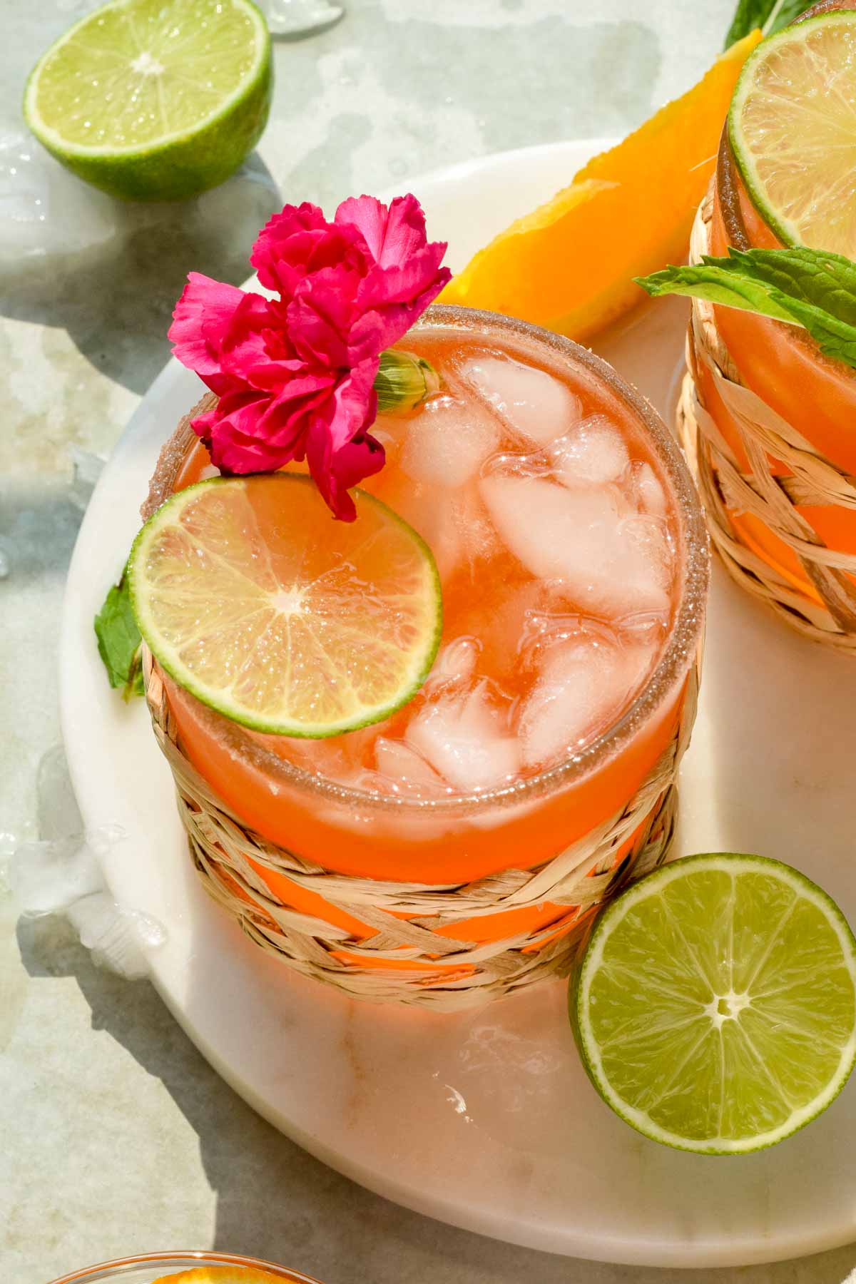 refreshing Italian Margarita garnished with hibiscus, lime wedge, and crushed ice. 