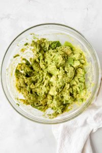 mashed avocados with lime juice and seasoning.