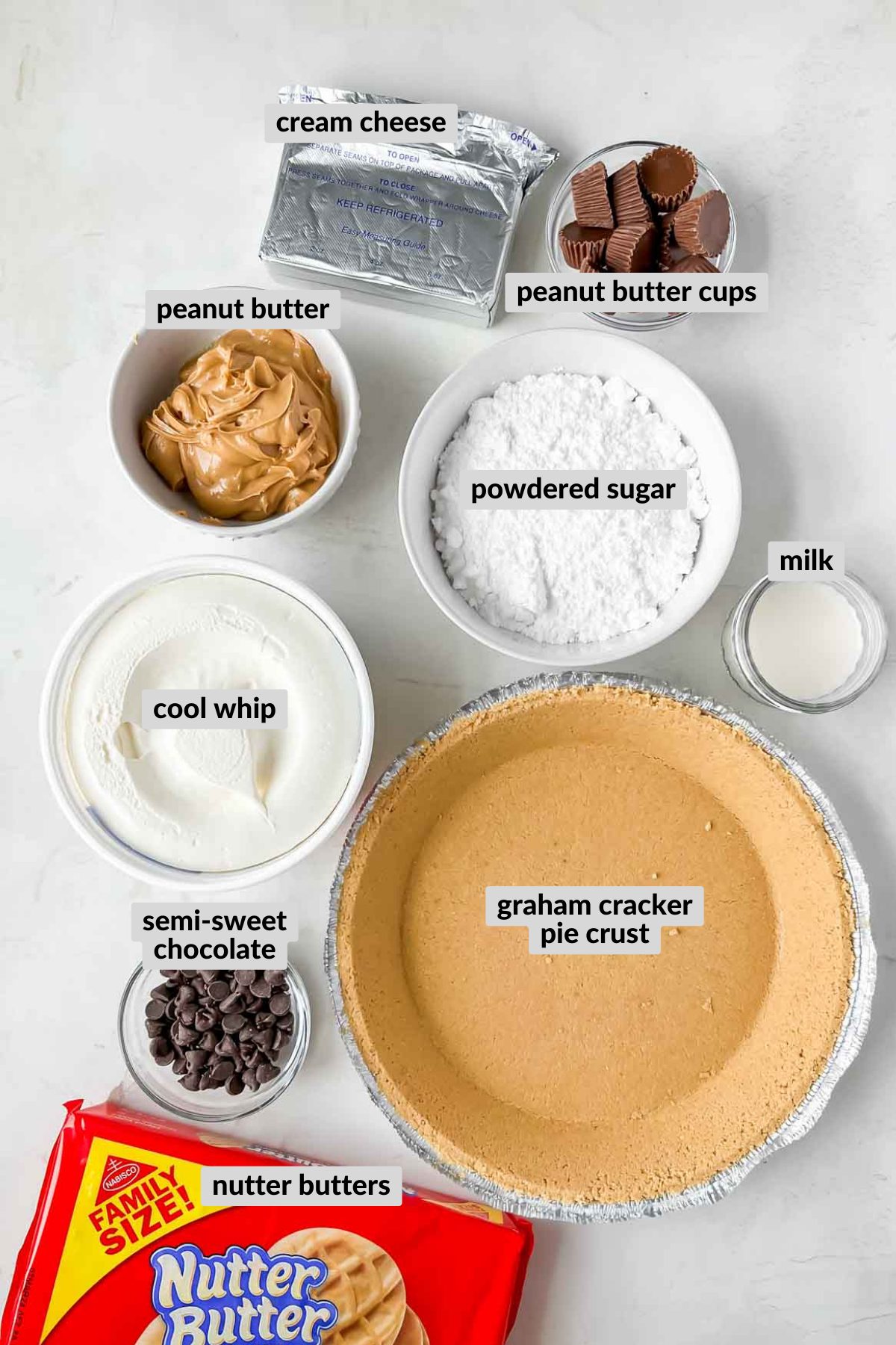nutter butter pie ingredients in individual bowls on cream background. 