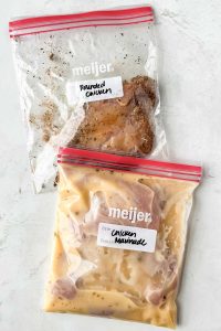 two plastic baggies filled with two different marinades for chicken breasts.
