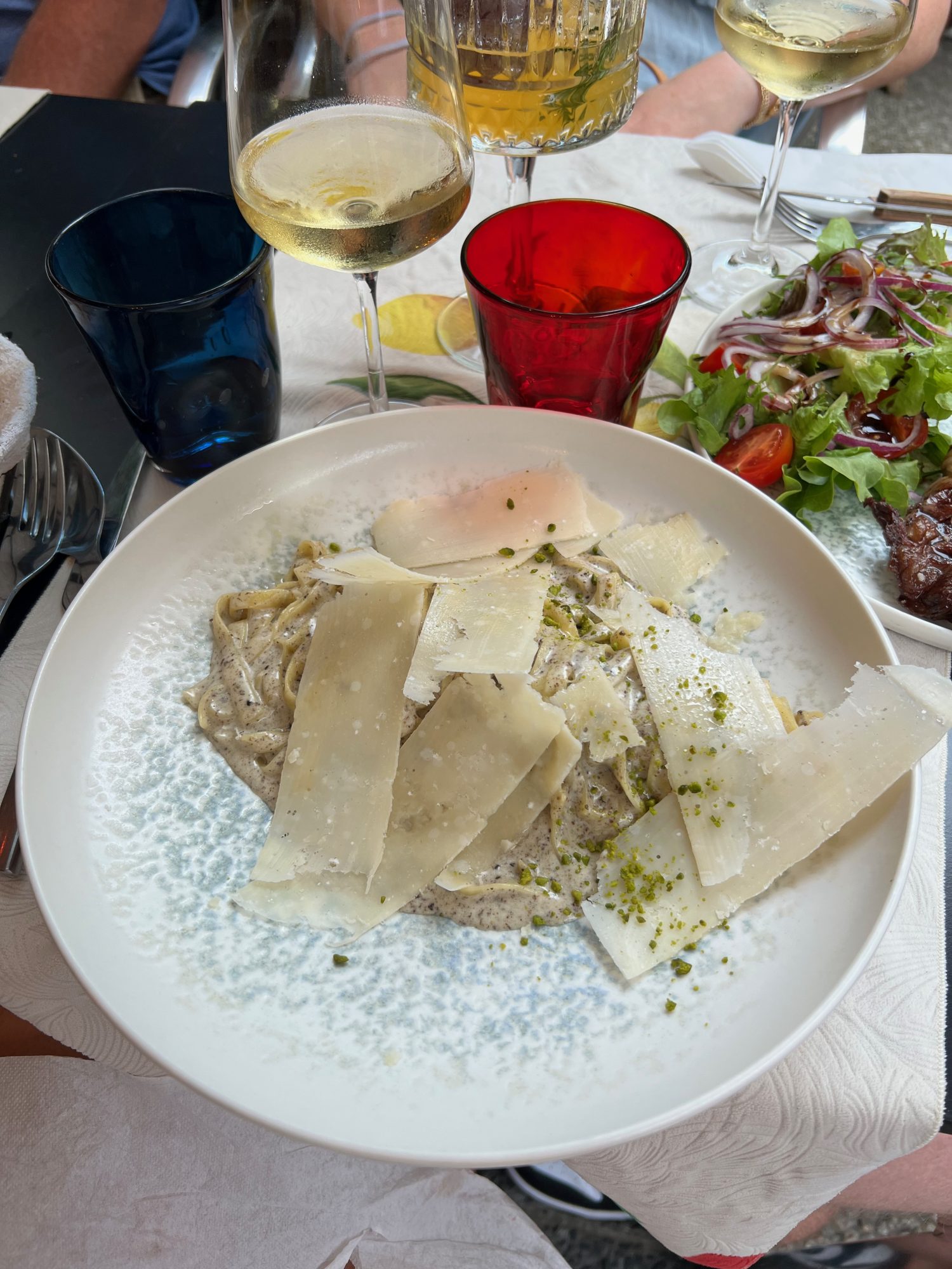 truffle pasta with white wine on white table cloth.