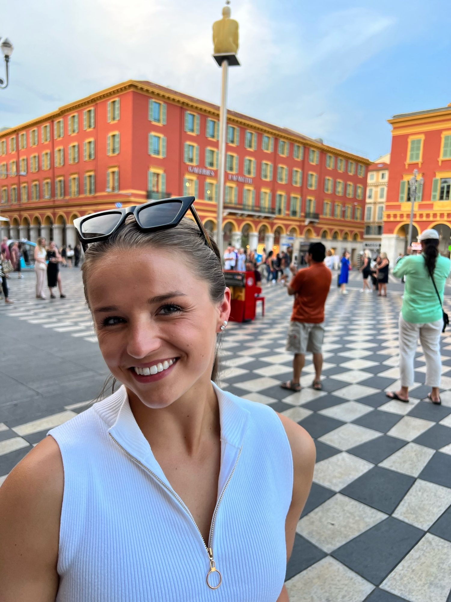 close up of Courtney smiling in front of the city center in Old Nice.