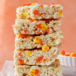 5 stacked candy corn rice krispie treats on parchment paper.
