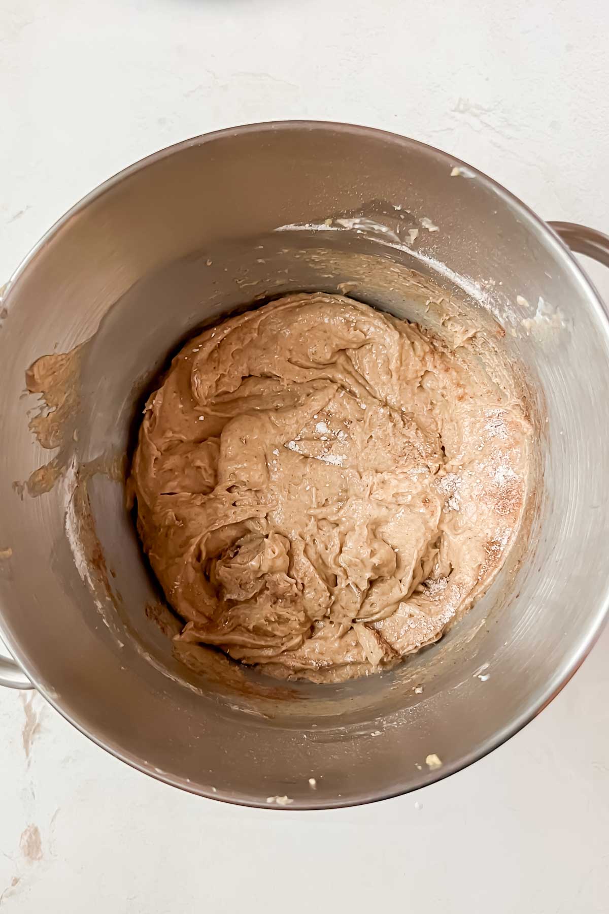 cinnamon donut bread batter mixed in silver mixing bowl.