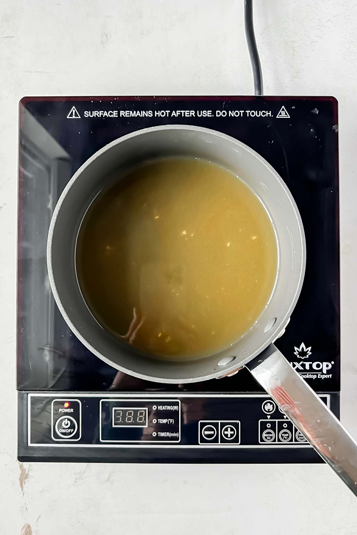 melted butter in small sauce pot on electric burner.