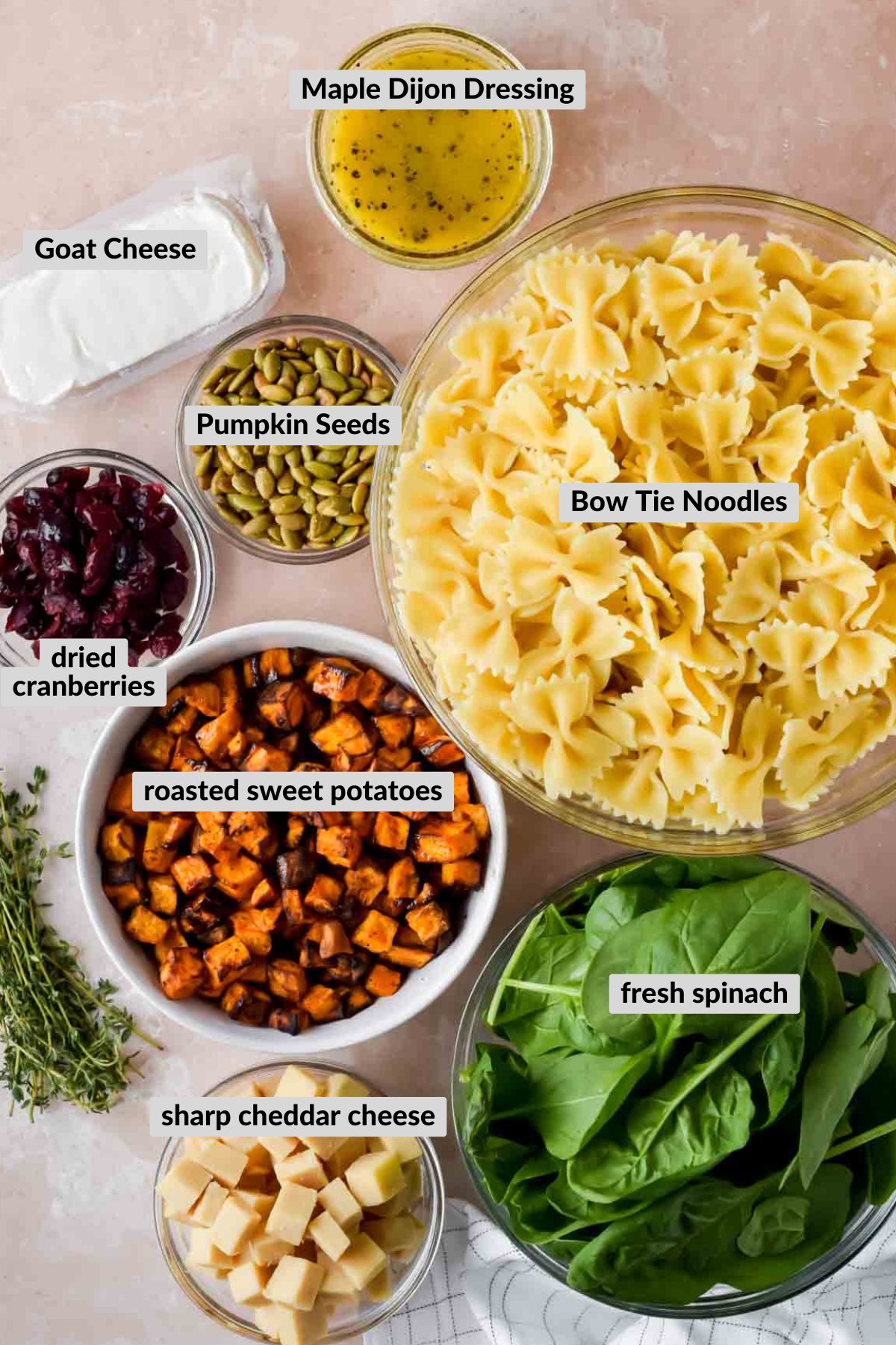labeled ingredients for fall pasta salad in individual bowls.