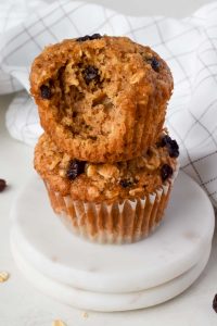 two oatmeal raisin muffins stacked on top of each other.