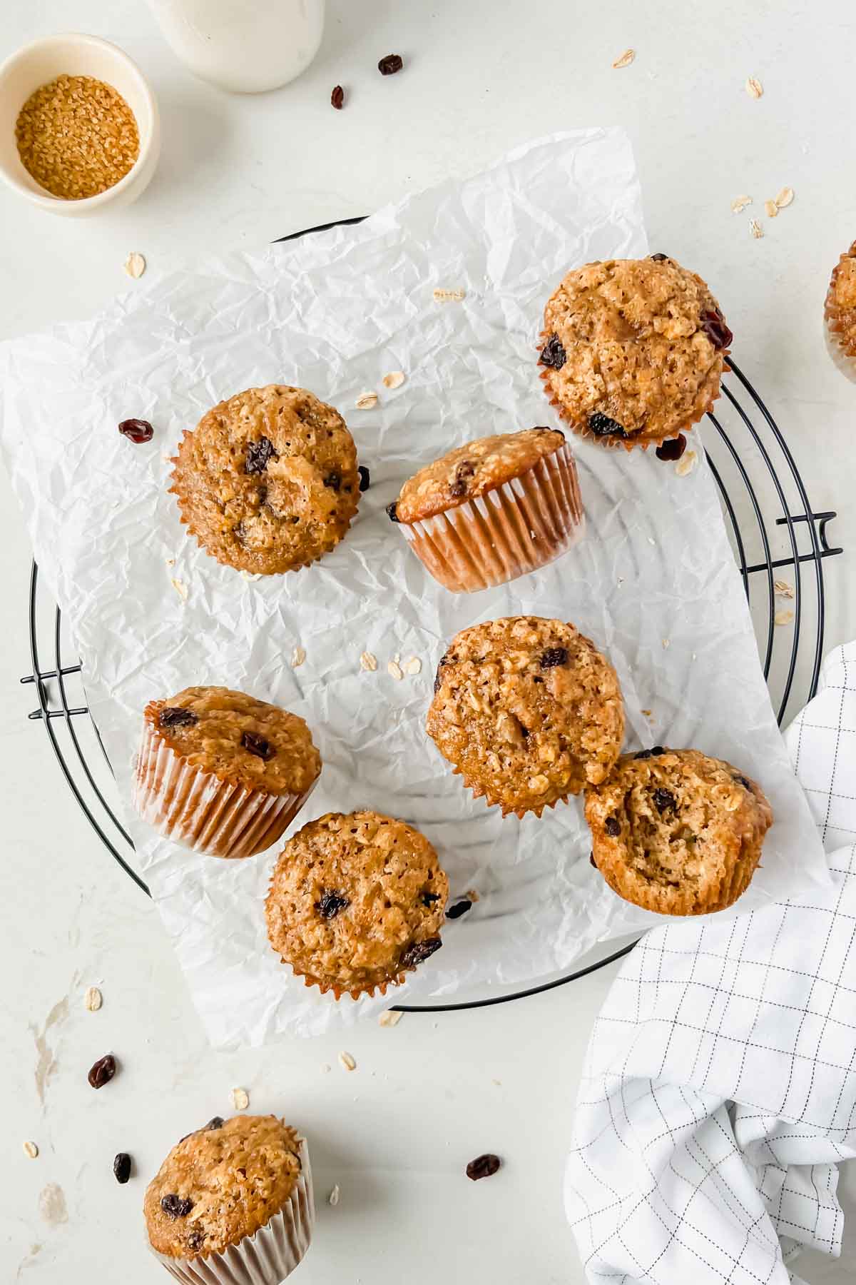 baked oatmeal raisin muffins on parchment.