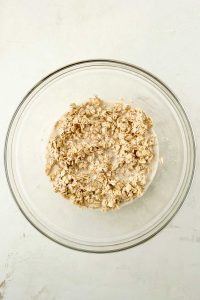 oats and milk in glass mixing bowl.