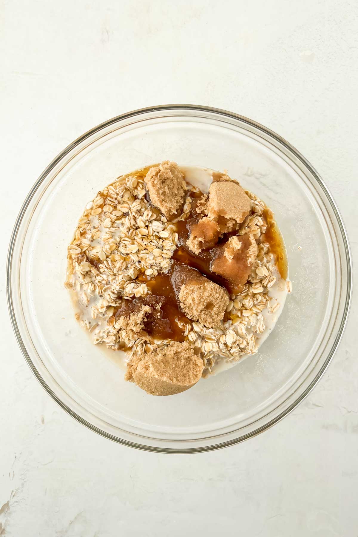 brown sugar and oats in glass mixing bowl.