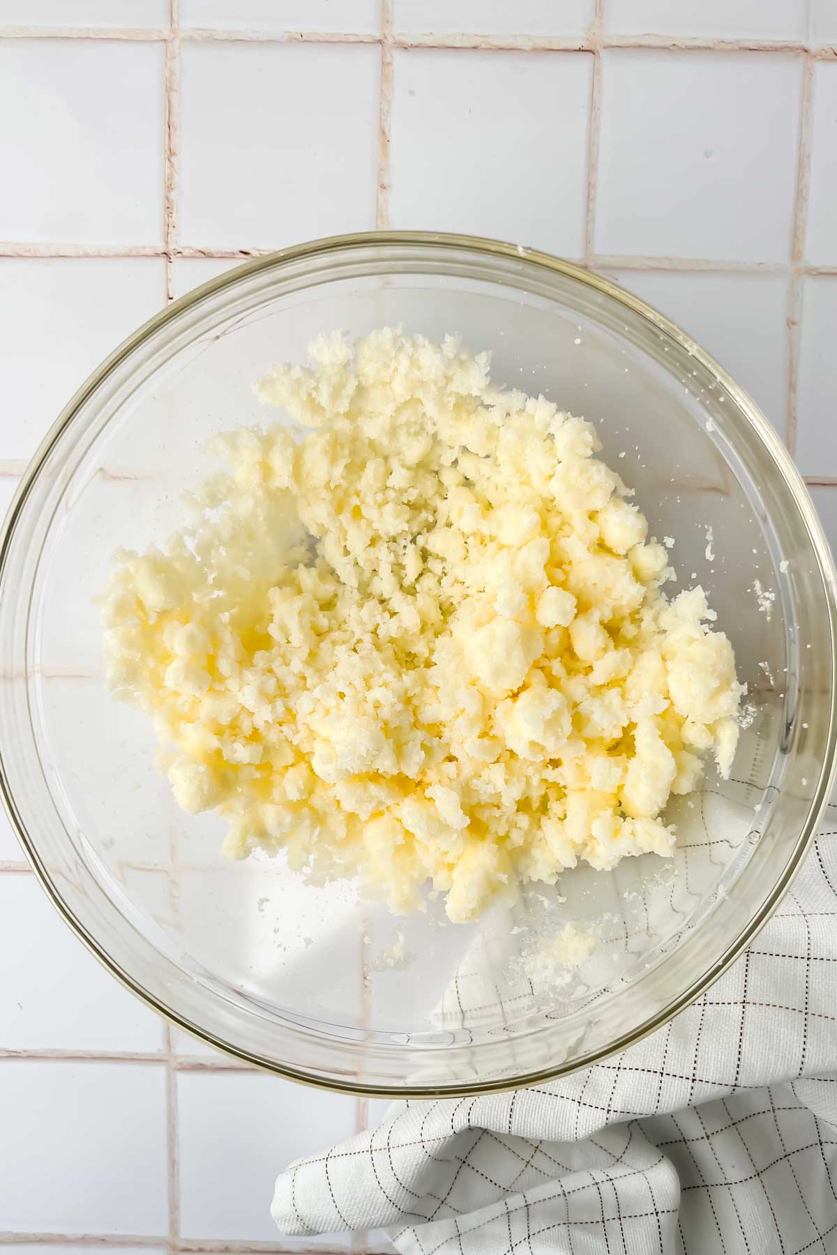 butter and sugar creamed together in glass mixing bowl.