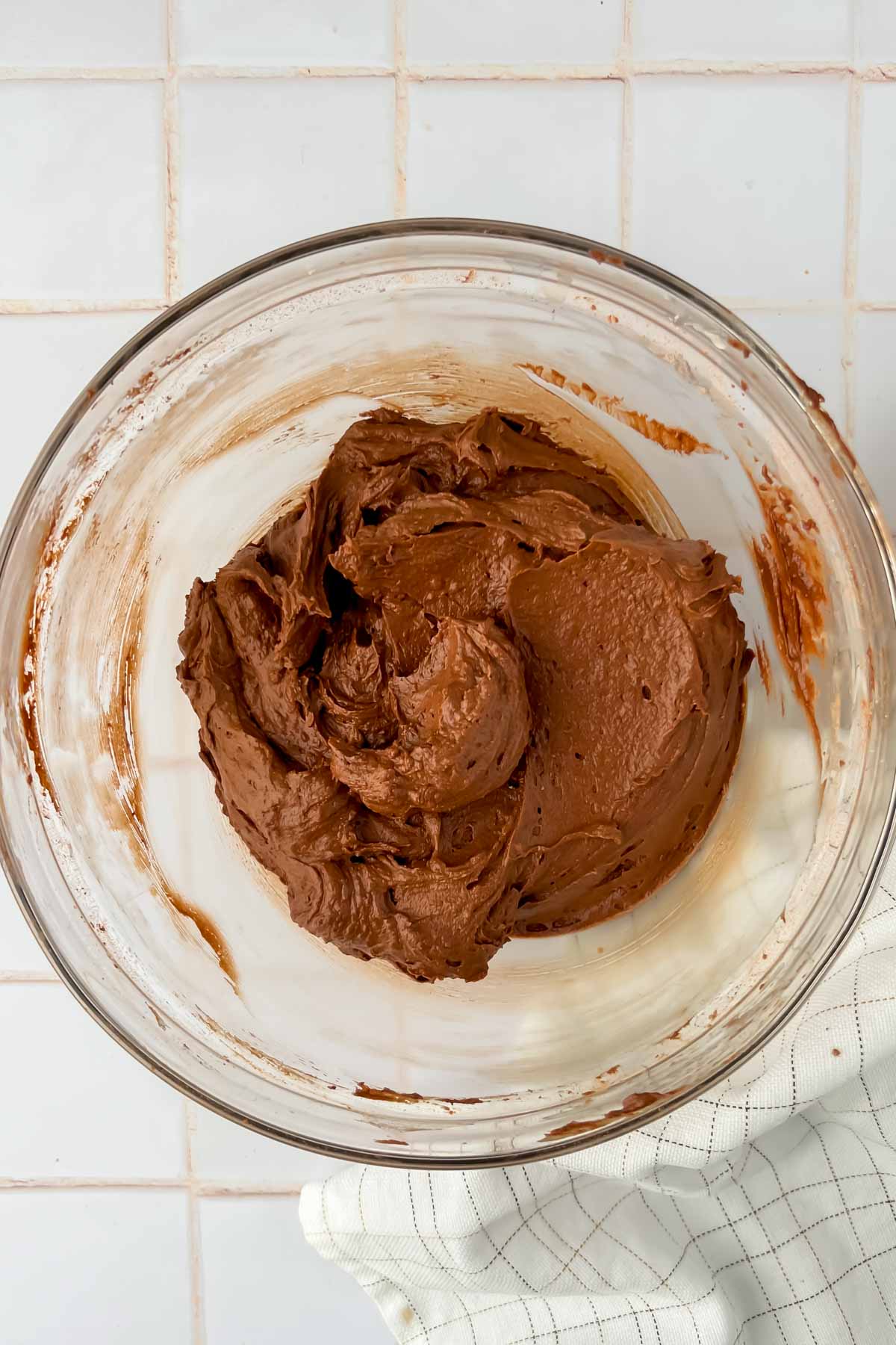 chocolate batter mixed in glass mixing bowl.
