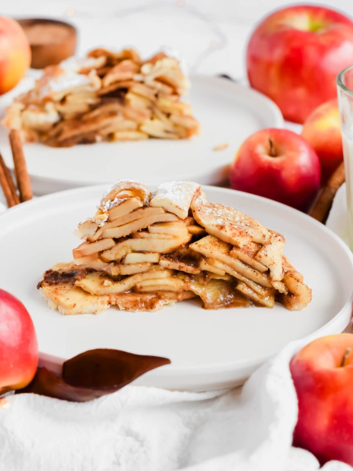 easy apple pie with store-bought crust on a white plate with additional slice in background.