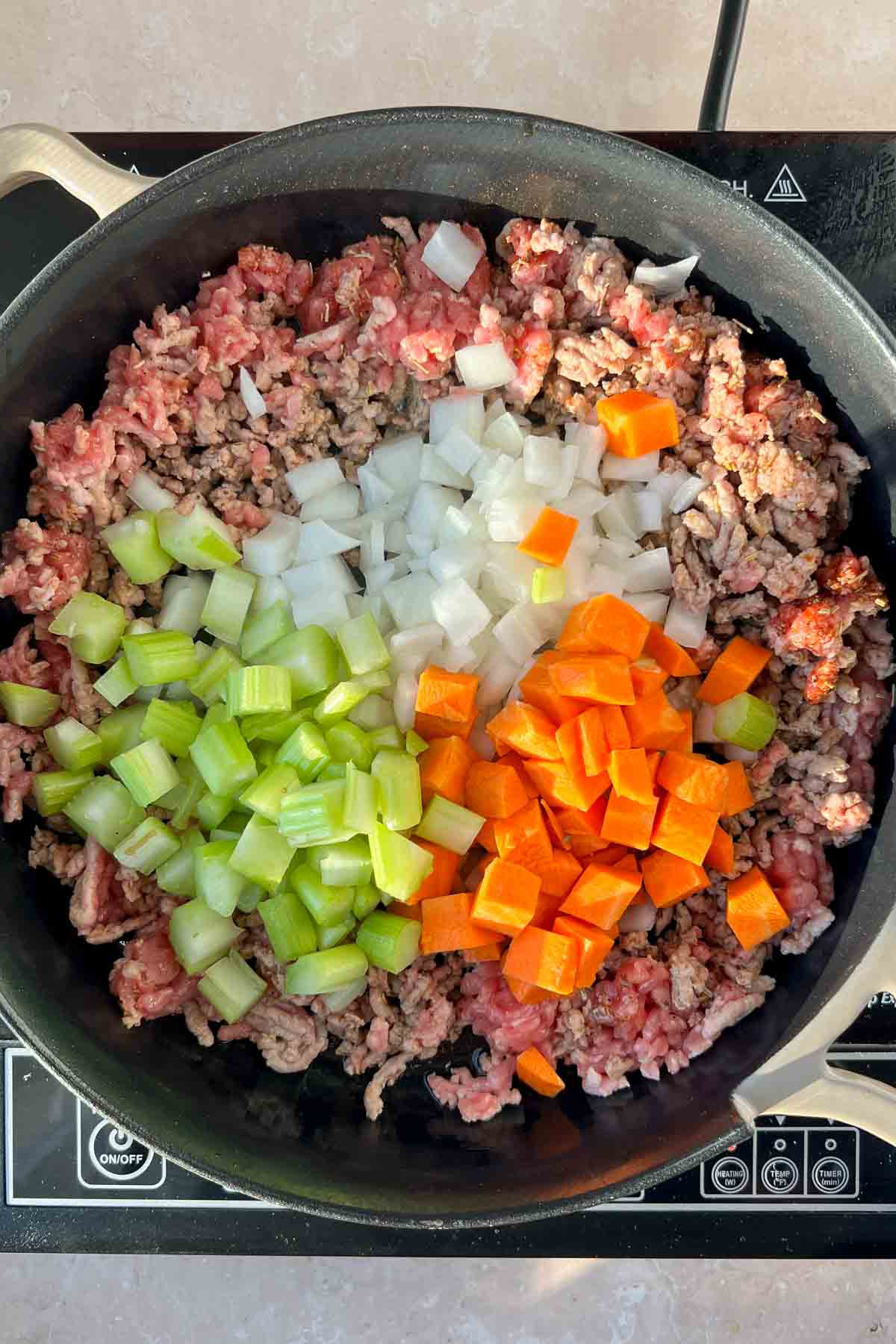 ground sausage and chopped celery, onions, and carrots in skillet.