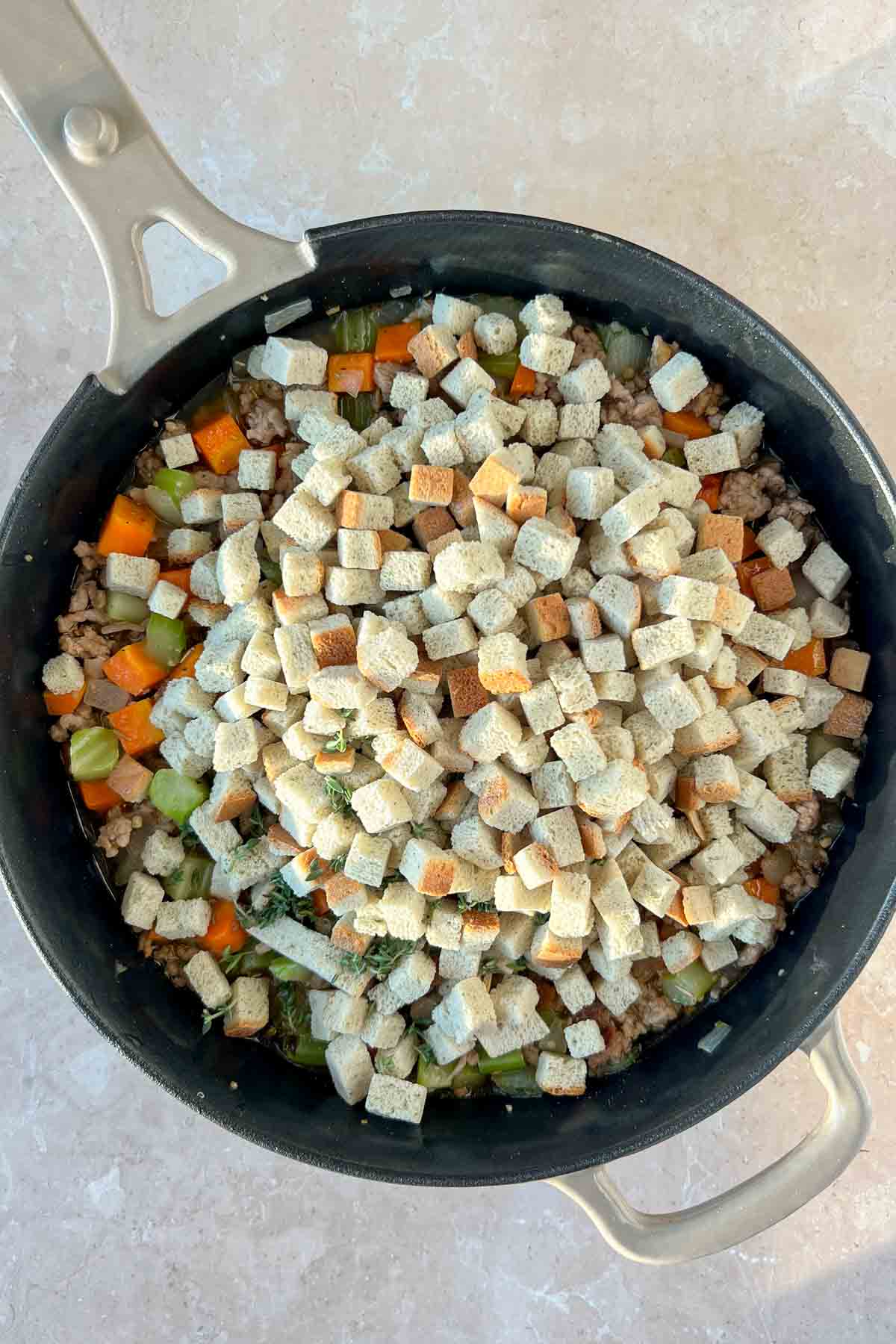 premade stuffing added to skillet with veggies and ground sausage.